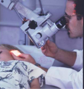 Dr. Pransky using a microscope to examine an ear